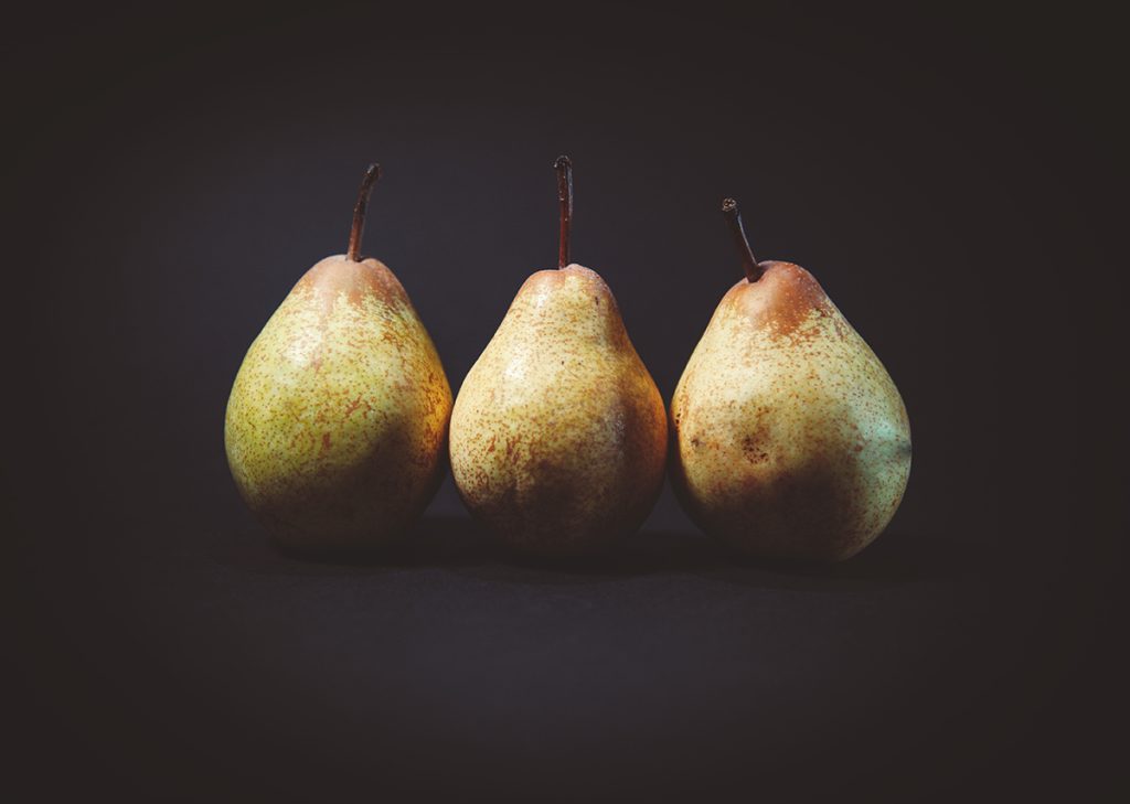 Trio of pears on a black background